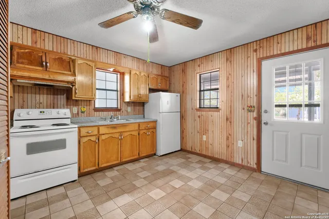 a kitchen with granite countertop cabinets and window