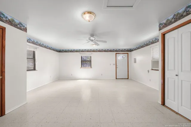 a view of a livingroom with a ceiling fan and window