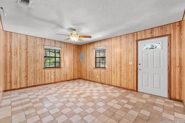 an empty room with windows and closet