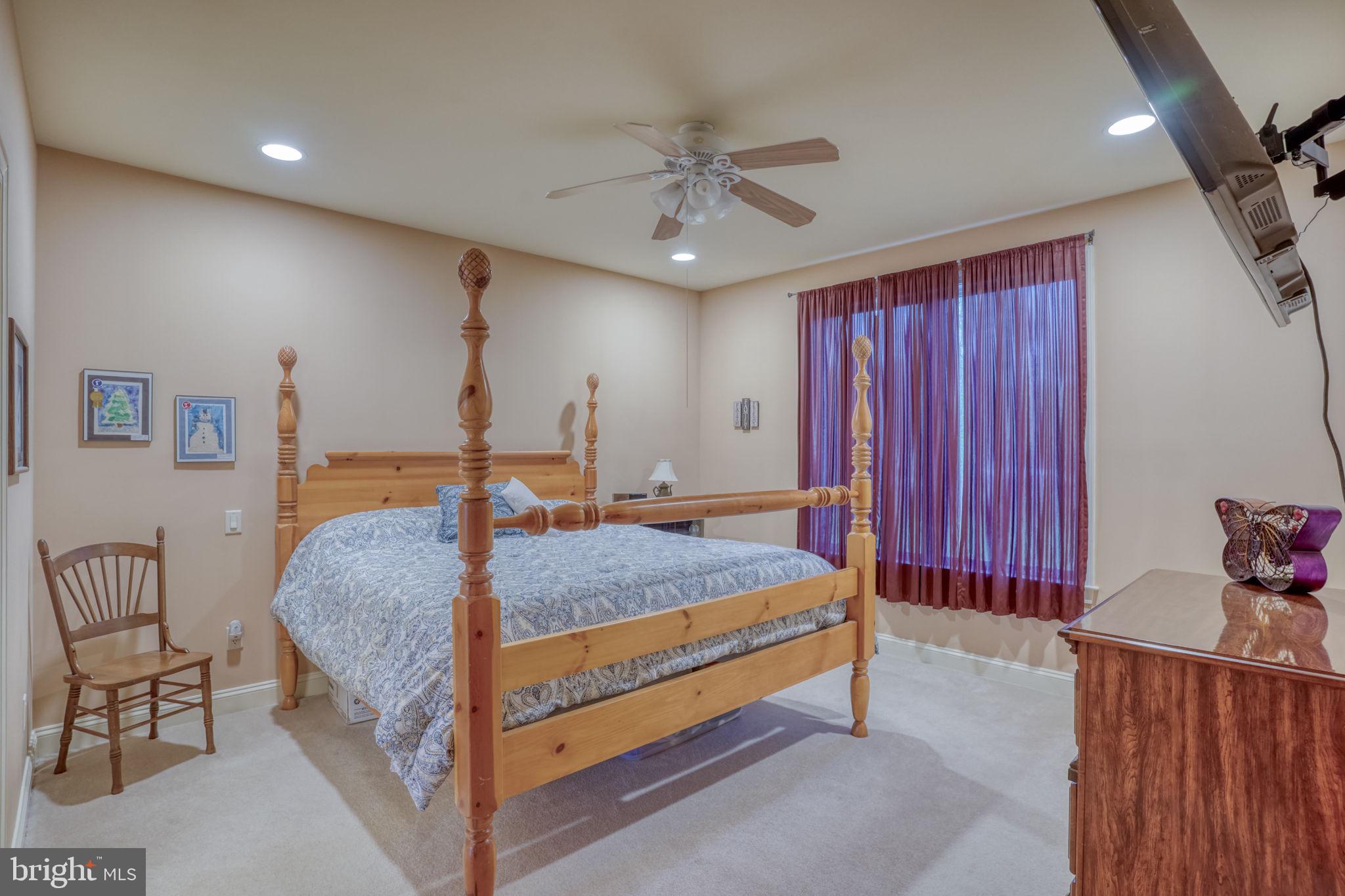56 Coventry Court Dover, DE 19901 - Photo 26 of 53 a spacious bedroom with a bed and a chandelier