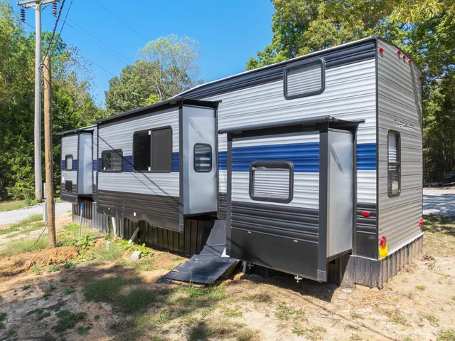 a view of a deck with two chair and a floor to ceiling window
