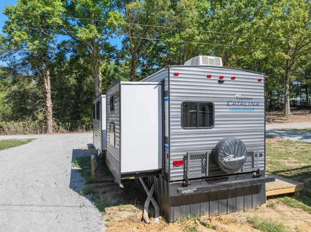 a bathroom with a sink a toilet a mirror and shower