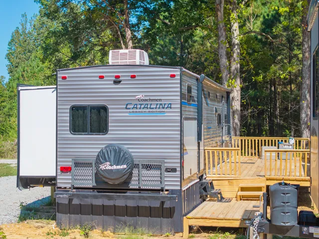 a view of a house with a wooden deck and a yard