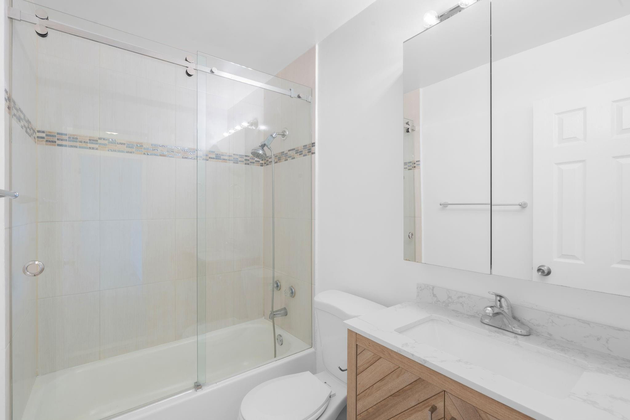 3262 Pierce Street Hollywood, FL 33021 - Photo 20 of 35 a bathroom with a granite countertop sink toilet and shower