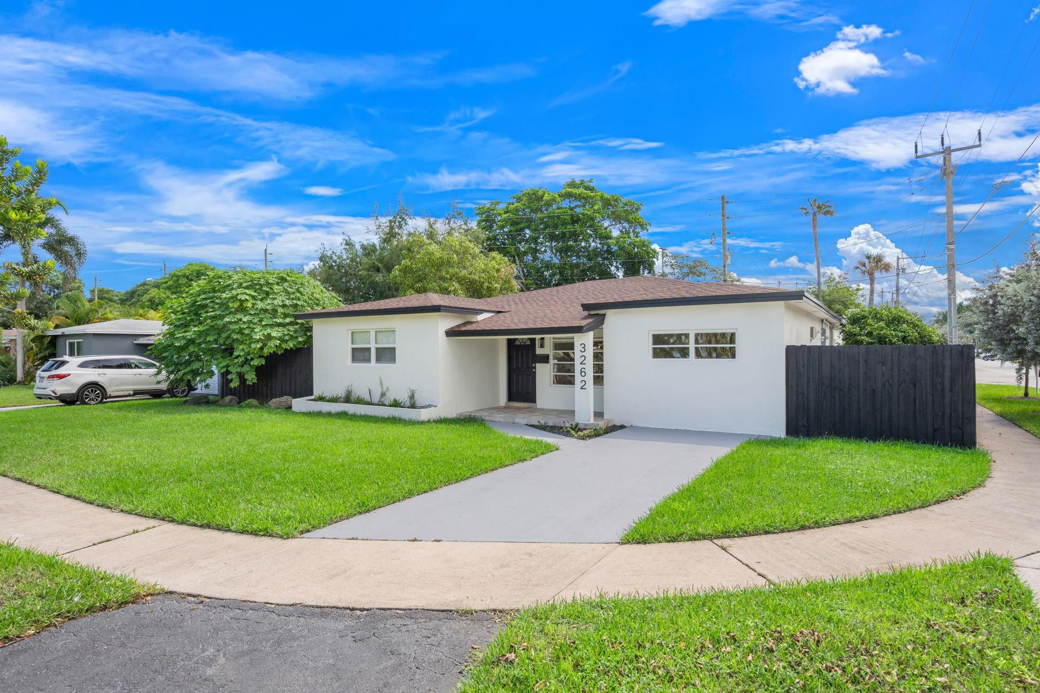 3262 Pierce Street Hollywood, FL 33021 - Photo 2 of 35 a front view of a house with a garden and yard
