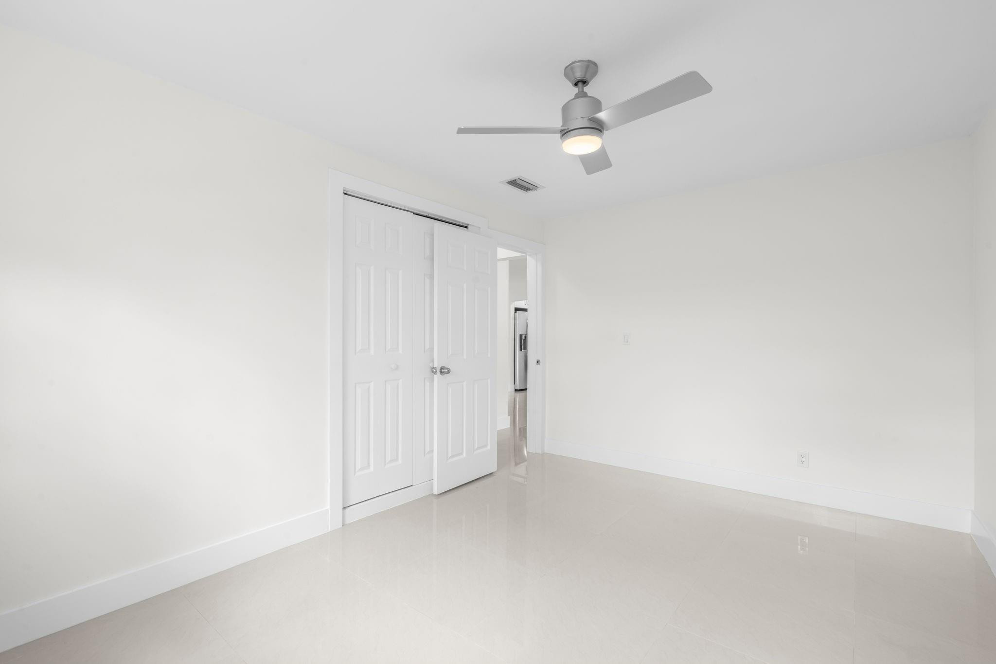 3262 Pierce Street Hollywood, FL 33021 - Photo 22 of 35 an empty room with a ceiling fan and a window