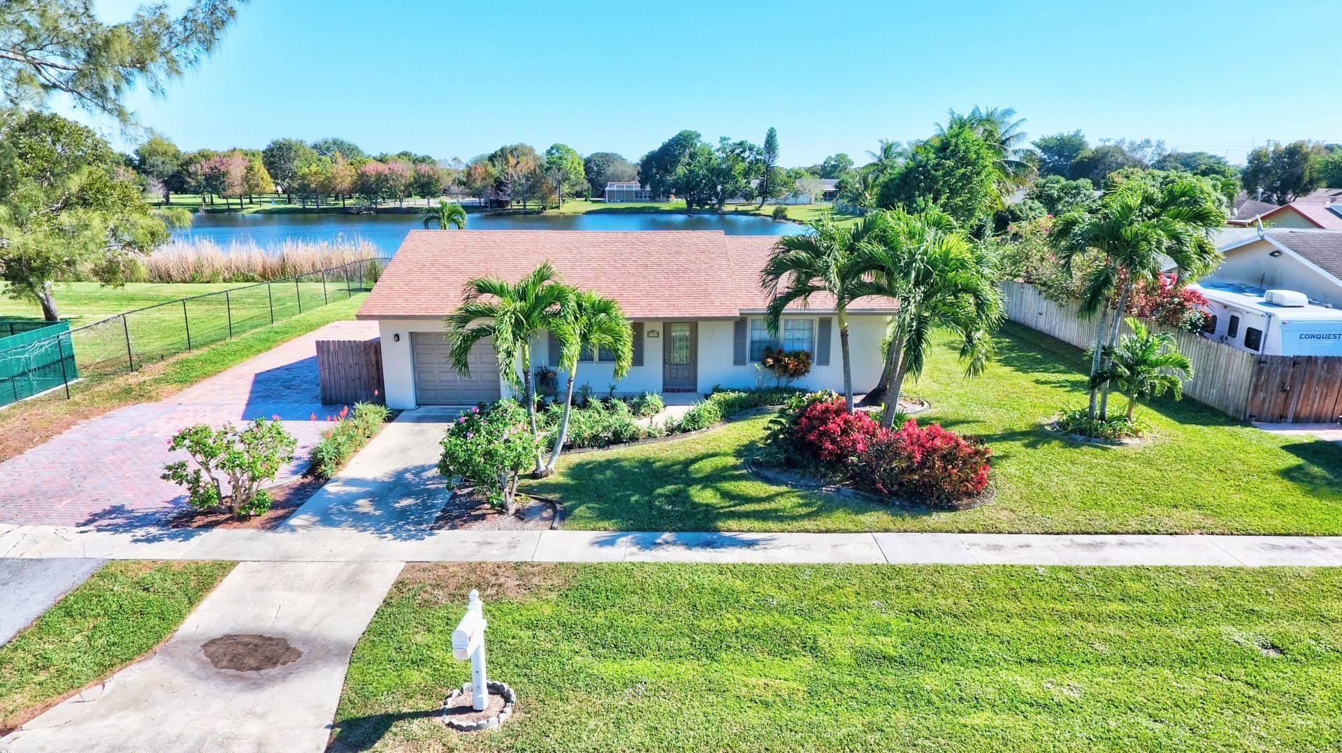 9989 Liberty Road Boca Raton, FL 33434 - Photo 1 of 44 a view of a garden with a lake