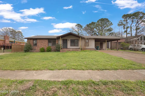 a front view of house with yard and green space