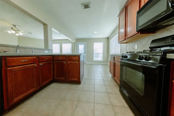 a kitchen with a sink and a stove top oven