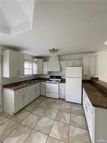 a kitchen with a stove top oven and cabinets