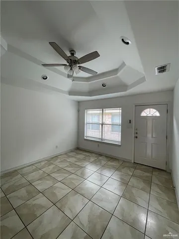 a view of an empty room and a window
