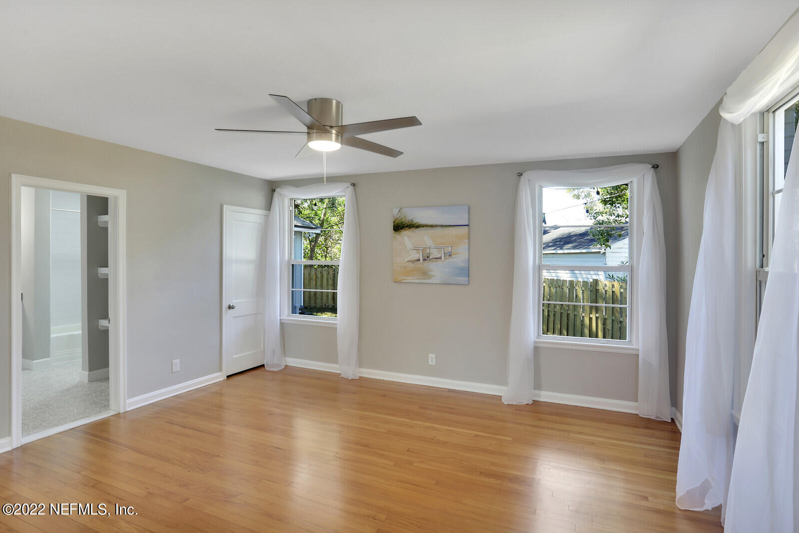 4206 Birmingham Road Jacksonville, FL 32207 - Photo 25 of 32 a view of an empty room with a window and wooden floor