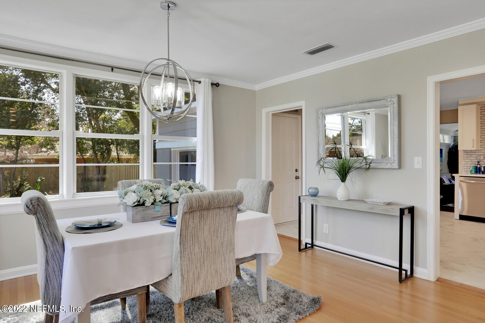 4206 Birmingham Road Jacksonville, FL 32207 - Photo 8 of 32 a dining room with furniture a chandelier and wooden floor