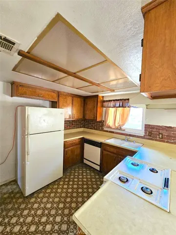 a kitchen that has a sink and a stove in it