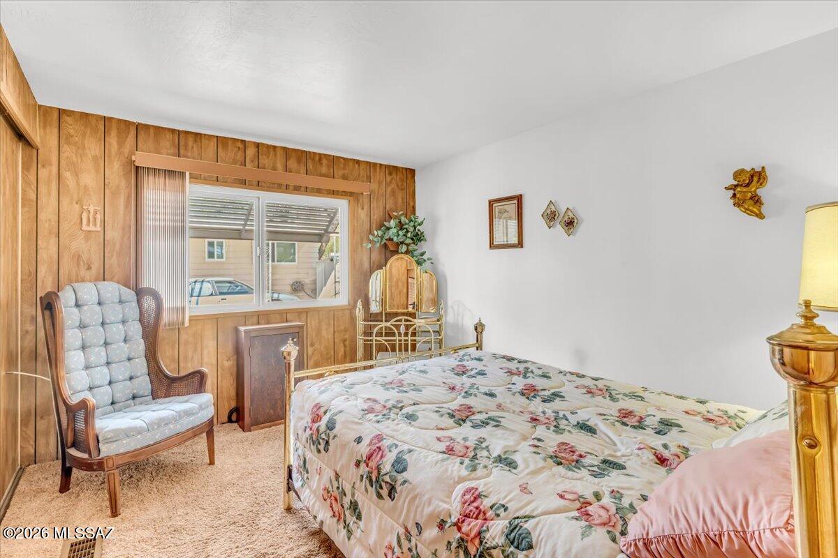 5840 West Flying W Street Tucson, AZ 85713 - Photo 24 of 38 a bedroom with a bed and a chair