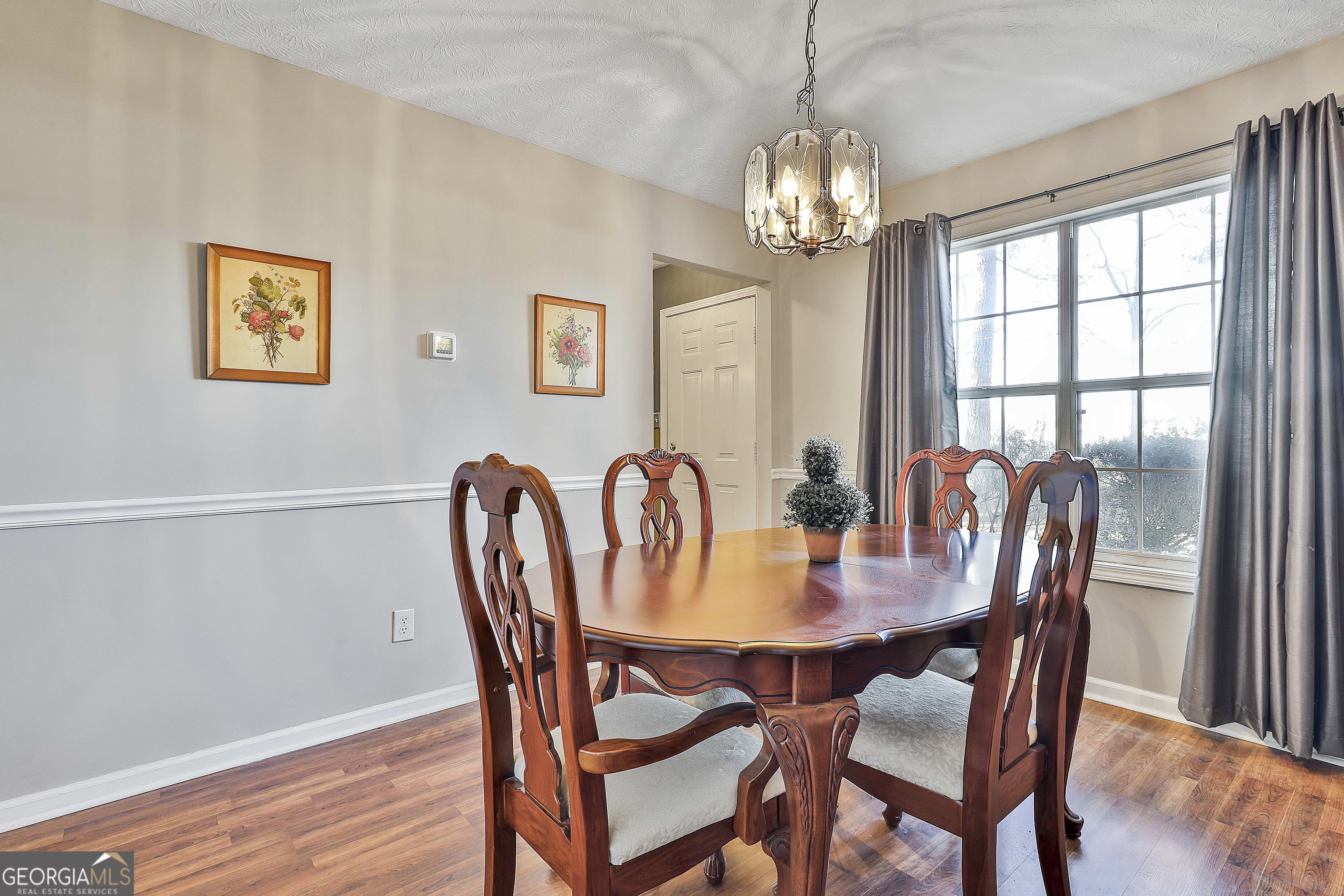 809 Lora Smith Road Newnan, GA 30265 - Photo 23 of 40 a view of a dining room with furniture window and wooden floor