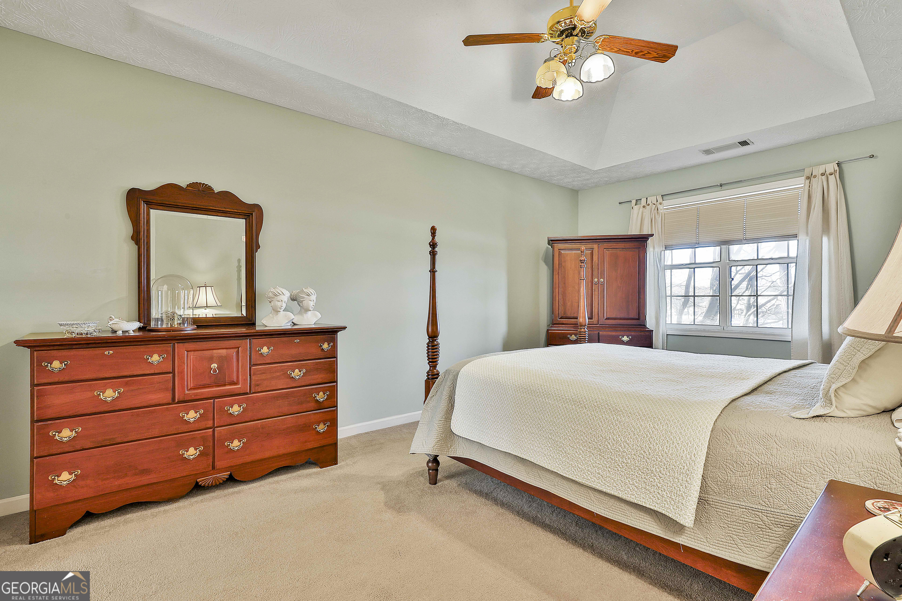 809 Lora Smith Road Newnan, GA 30265 - Photo 25 of 40 a bedroom with a bed and a dresser