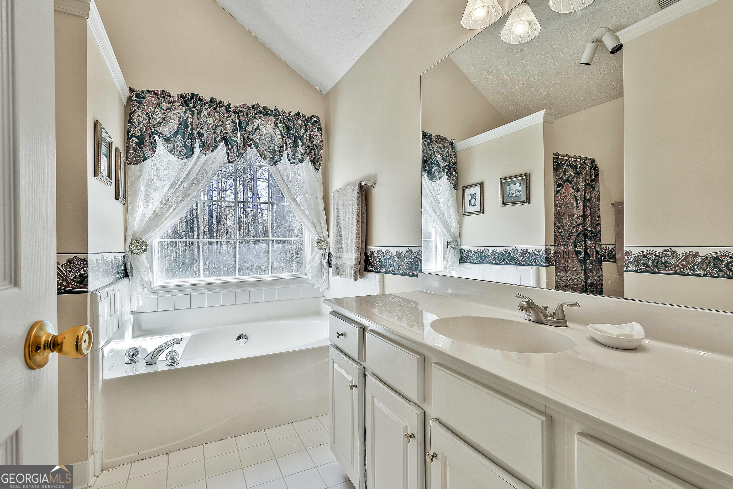 809 Lora Smith Road Newnan, GA 30265 - Photo 27 of 40 a bathroom with a sink and a mirror
