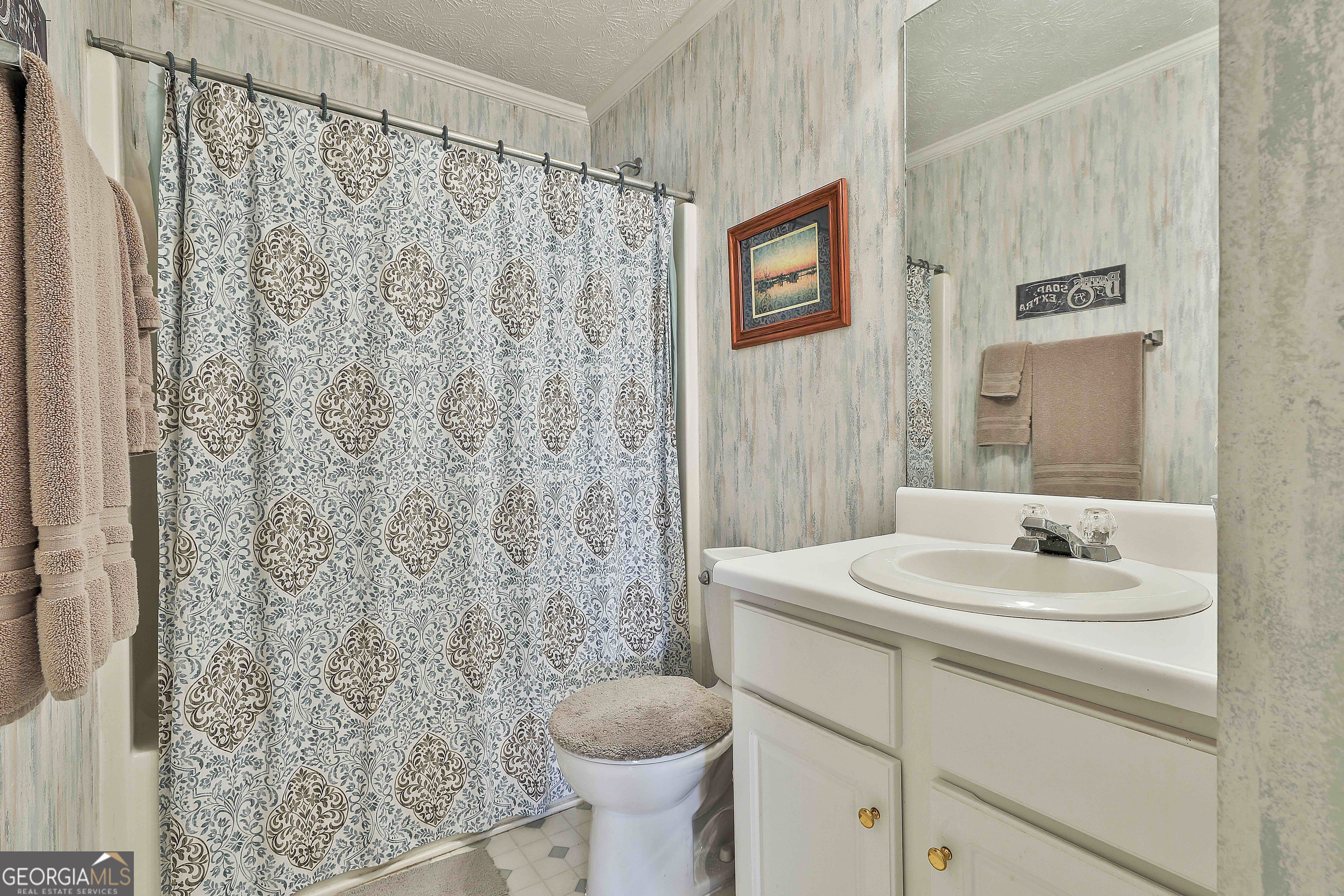 809 Lora Smith Road Newnan, GA 30265 - Photo 30 of 40 a bathroom with a sink toilet and shower