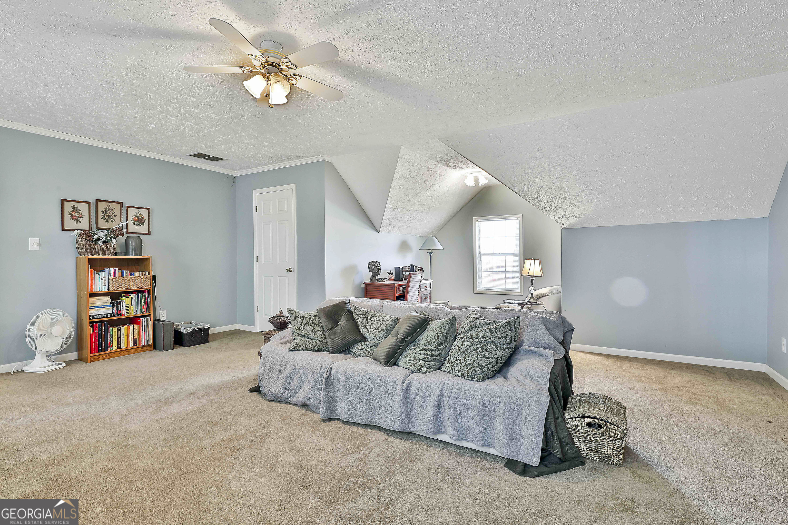 809 Lora Smith Road Newnan, GA 30265 - Photo 33 of 40 a bedroom with a bed furniture and a chandelier