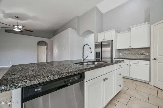 a kitchen with granite countertop a sink and cabinets