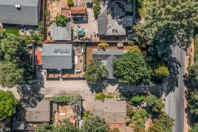 an aerial view of multiple houses with yard