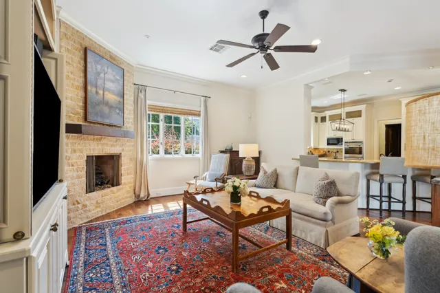 a living room with furniture fireplace and a window