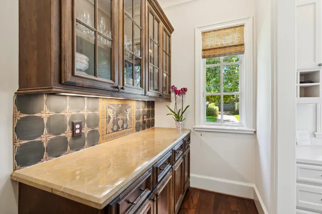 an outdoor space with wooden floor and windows