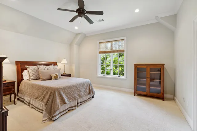 a spacious bedroom with a bed and a window