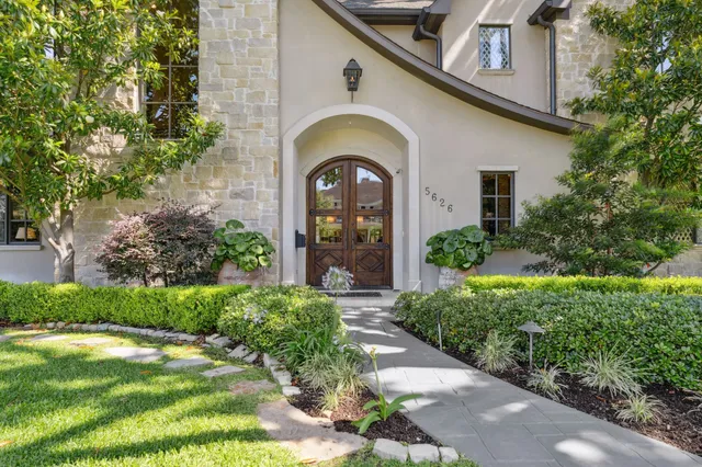 a front view of a house with garden