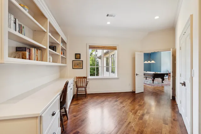 a view of a living room with furniture and wooden floor