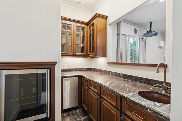 a kitchen with granite countertop a sink and cabinets
