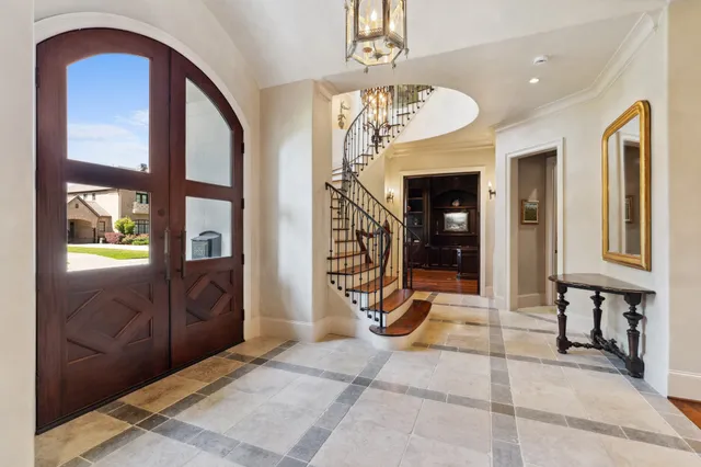 a view of a entryway door of living room and chandelier