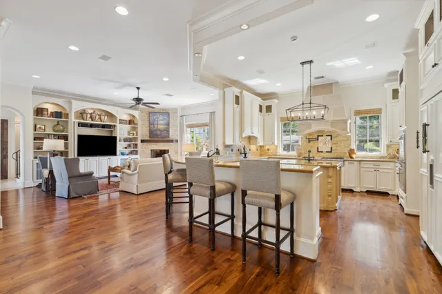 a large kitchen with a table and chairs