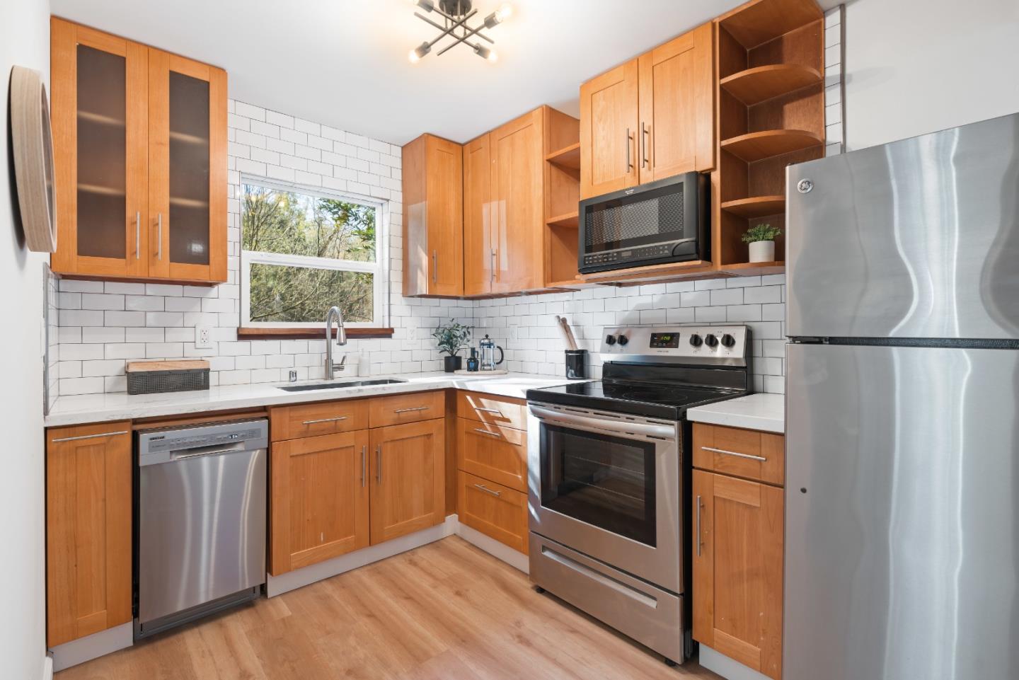 7475 East Zayante Road Felton, CA 95018 - Photo 12 of 52 a kitchen with stainless steel appliances granite countertop a stove a sink and a refrigerator