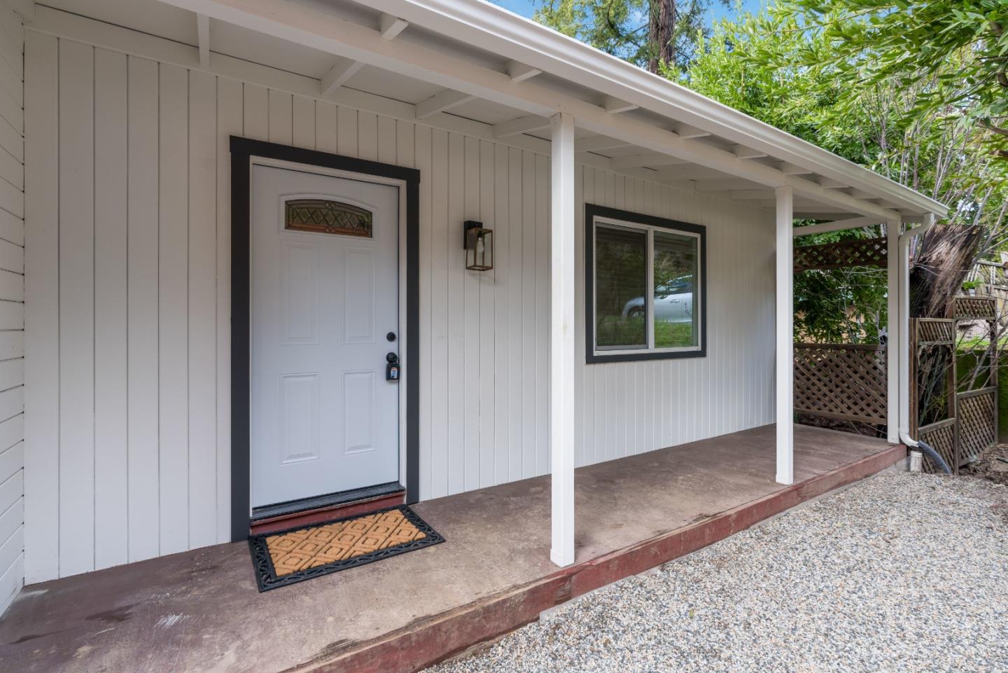 7475 East Zayante Road Felton, CA 95018 - Photo 40 of 52 a backyard of a house with basket ball court and floor to ceiling window