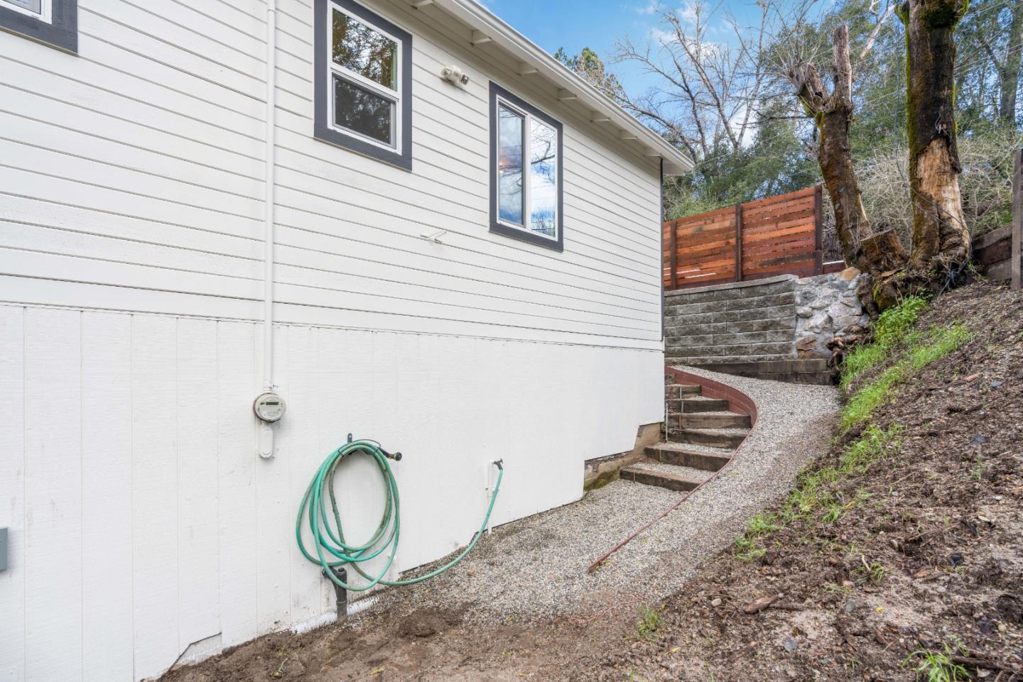 7475 East Zayante Road Felton, CA 95018 - Photo 41 of 52 a backyard of a house with wooden fence and large trees