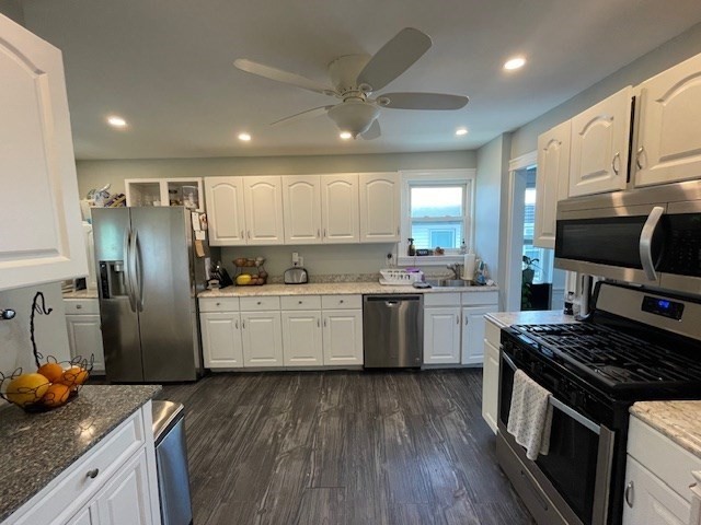 a kitchen with a sink stainless steel appliances and window