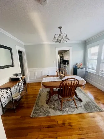 a living room with furniture pool table and window