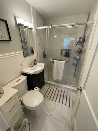 a bathroom with a toilet sink and shower