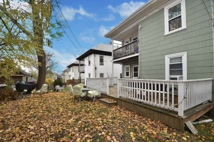 10 Arbroth Street, Unit 2 Boston, MA 02122 - Photo 7 of 8 a view of a house with a wooden bench in a yard