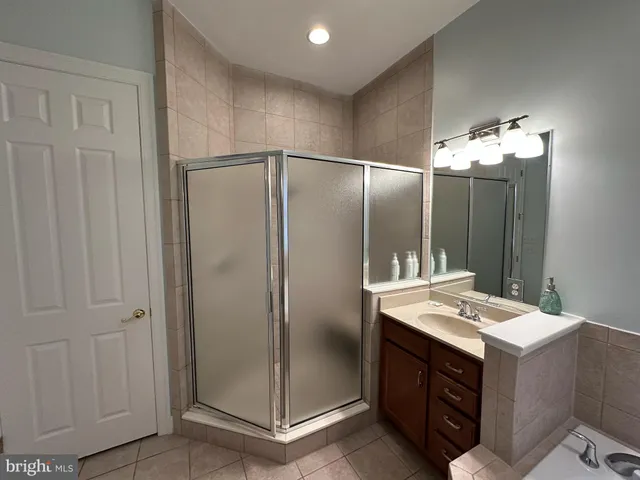 a bathroom with a sink vanity and a mirror