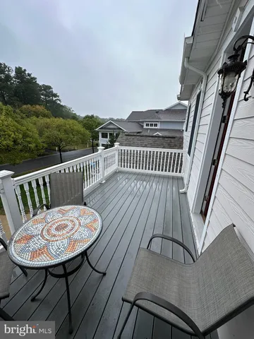 a view of a couches and table in the balcony