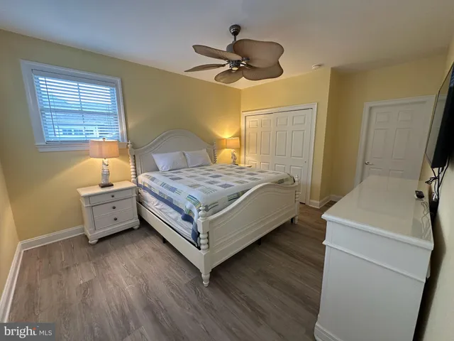a spacious bedroom with a bed and a table in it