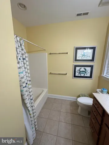 a bathroom with a toilet a sink and shower