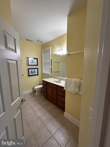 a large bathroom with a tub a sink and a mirror