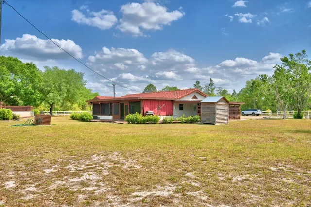 a front view of a house with a yard and a garage