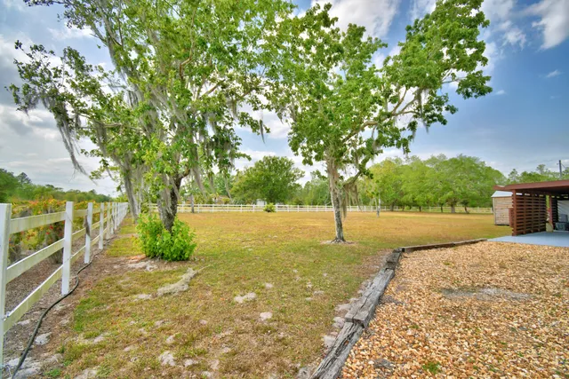a view of a dining room with furniture and a chandelier