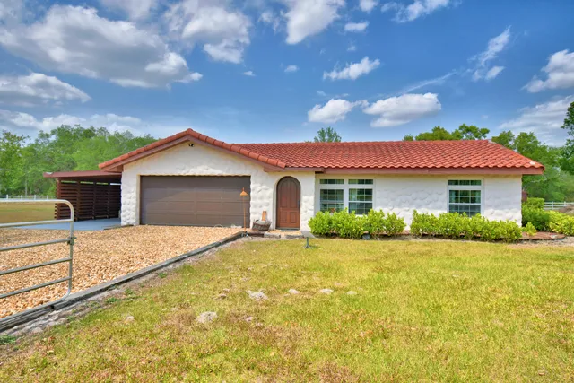 a front view of a house with wooden fence