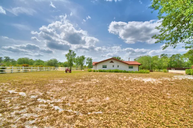 a room with pool table and windows